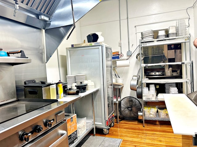 kitchen featuring light wood-type flooring and stainless steel range with electric cooktop