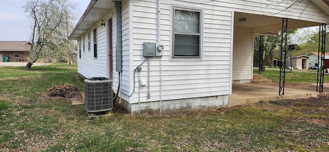 view of property exterior featuring a lawn and central AC unit