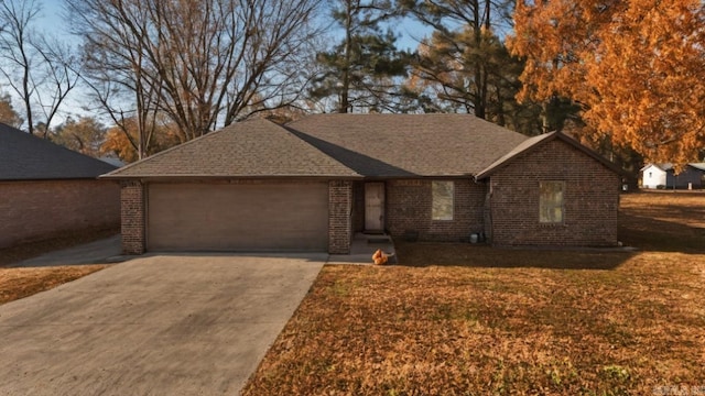 single story home featuring a garage and a front lawn