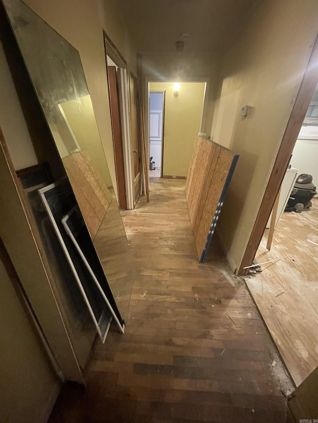 corridor with hardwood / wood-style flooring