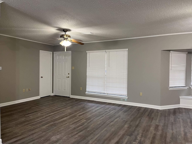 empty room with a textured ceiling, dark hardwood / wood-style floors, and crown molding