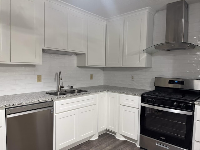 kitchen with white cabinets, sink, stainless steel appliances, and wall chimney range hood