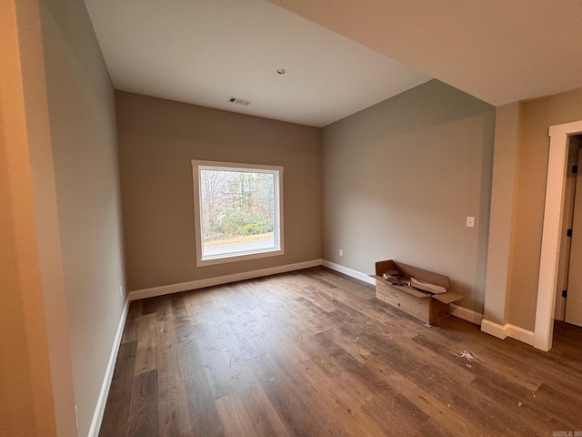 spare room with wood-type flooring