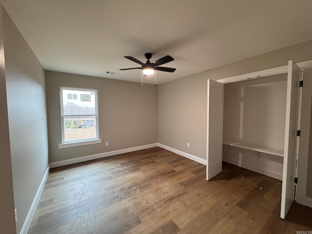 unfurnished bedroom featuring wood-type flooring and ceiling fan