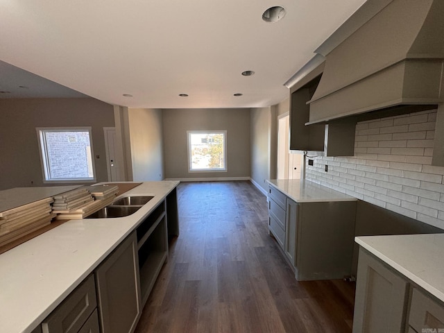 kitchen with gray cabinetry, sink, decorative backsplash, and dark wood-type flooring