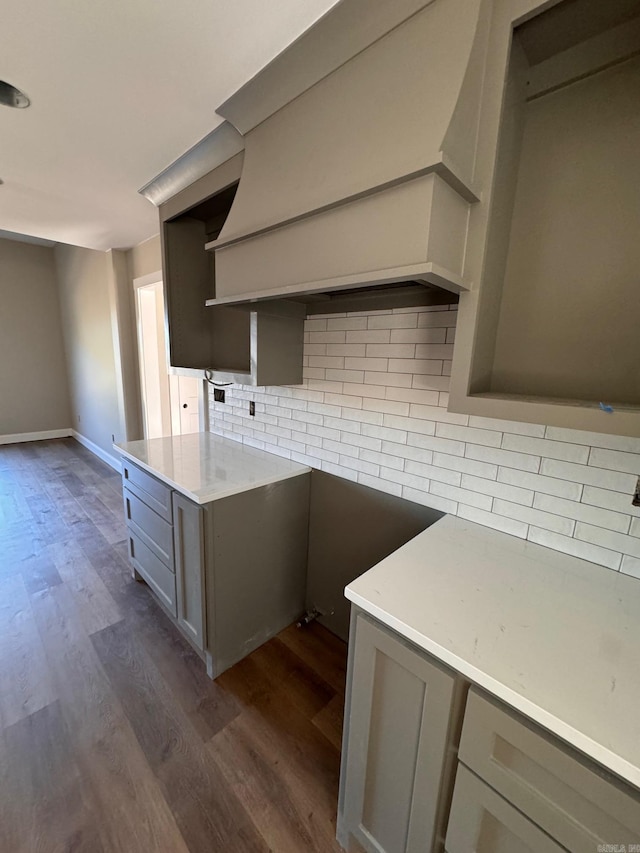 kitchen with gray cabinetry, backsplash, and dark hardwood / wood-style flooring