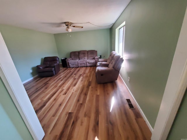 living room with ceiling fan and hardwood / wood-style floors