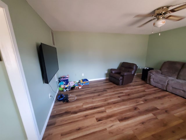 living room with wood-type flooring and ceiling fan