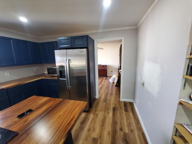 kitchen featuring blue cabinetry, light hardwood / wood-style floors, crown molding, and stainless steel appliances