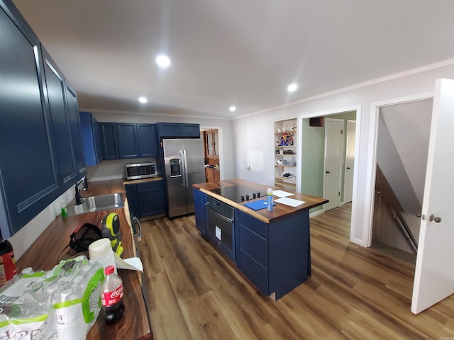 kitchen featuring sink, wood counters, dark hardwood / wood-style floors, blue cabinets, and appliances with stainless steel finishes