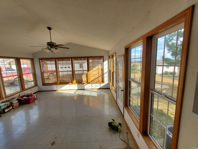 unfurnished sunroom featuring ceiling fan and vaulted ceiling