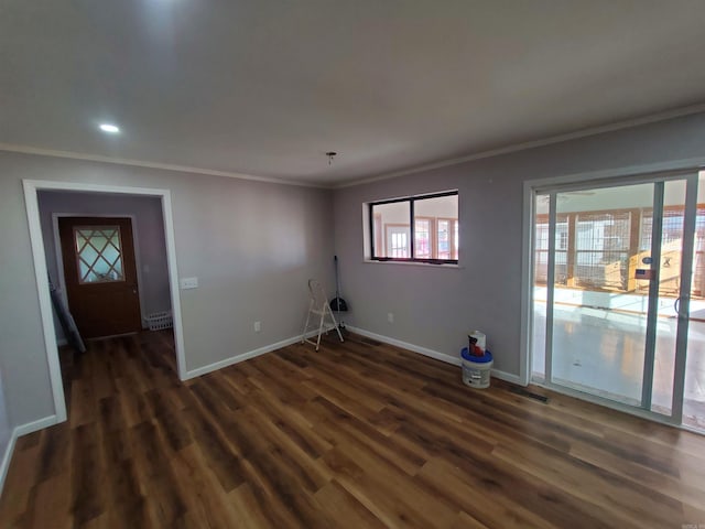 empty room with dark hardwood / wood-style floors and ornamental molding