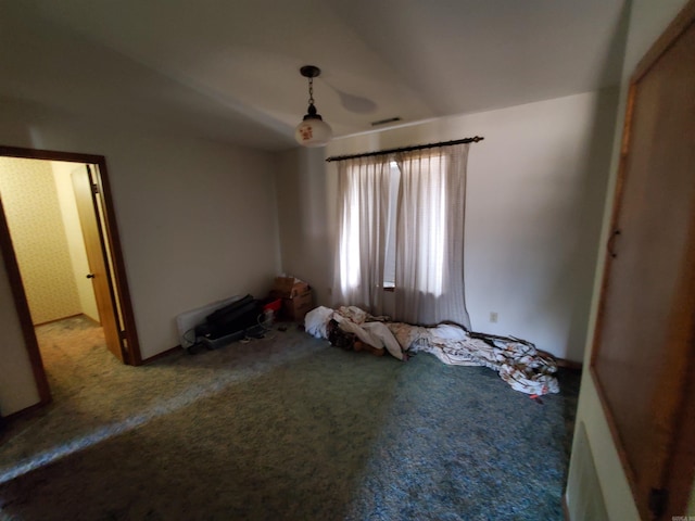 unfurnished bedroom featuring carpet flooring and vaulted ceiling