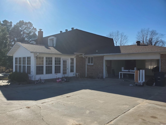 rear view of property featuring a garage