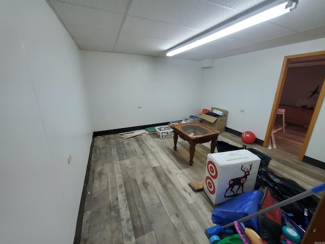 playroom with a paneled ceiling and light hardwood / wood-style flooring