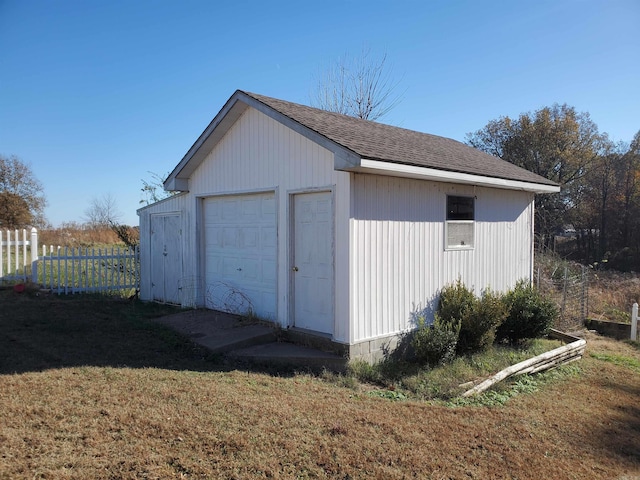 view of outbuilding featuring a yard and a garage