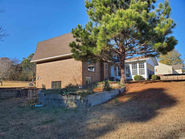 back of house featuring central AC unit