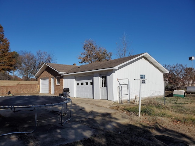 view of side of home featuring a trampoline