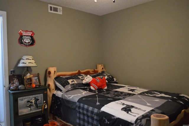 bedroom with visible vents and a textured ceiling