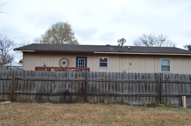 rear view of property featuring fence