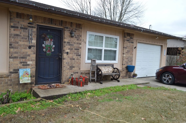 doorway to property with brick siding and an attached garage