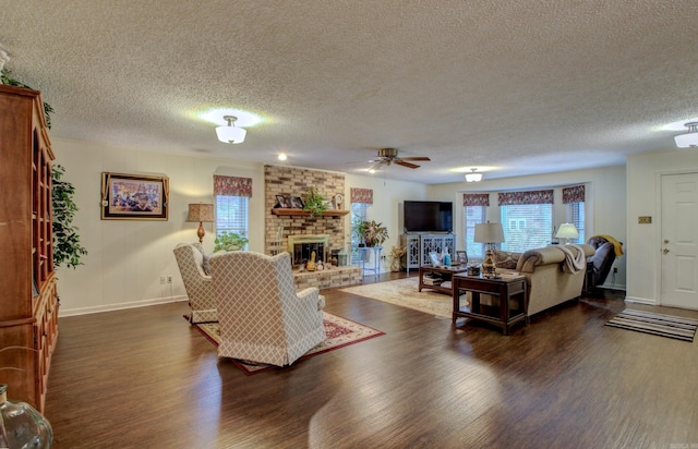 living room with a fireplace, ceiling fan, dark hardwood / wood-style flooring, and a textured ceiling