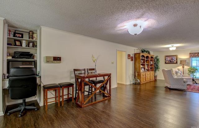 dining room featuring dark hardwood / wood-style flooring and a textured ceiling