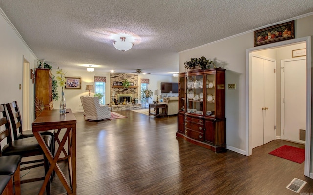 dining area with a textured ceiling and dark hardwood / wood-style floors