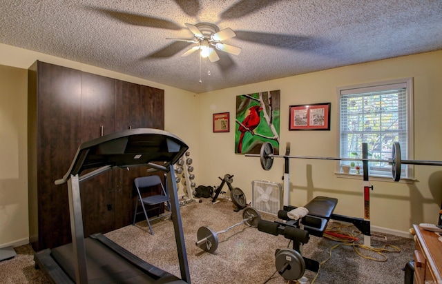 workout room with ceiling fan, carpet floors, and a textured ceiling