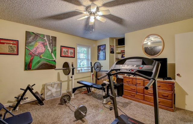 workout area featuring light carpet, a textured ceiling, and ceiling fan