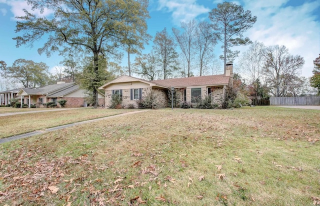 single story home featuring a front lawn