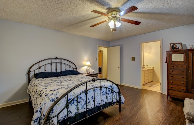 bedroom with ensuite bath, ceiling fan, dark hardwood / wood-style flooring, and a textured ceiling