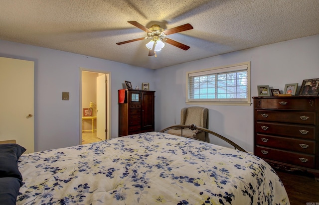 bedroom with hardwood / wood-style floors, a textured ceiling, ensuite bathroom, and ceiling fan