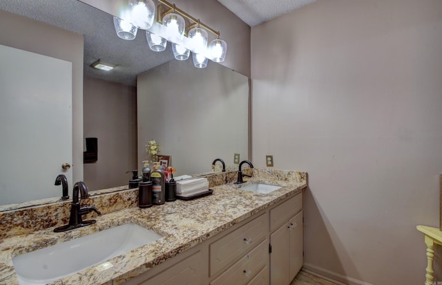 bathroom with vanity and a textured ceiling