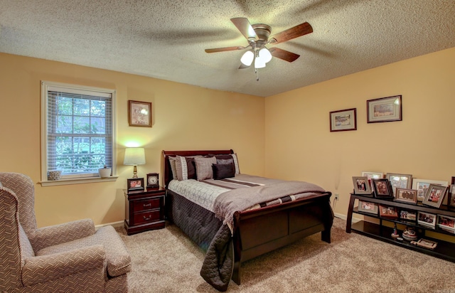 carpeted bedroom with ceiling fan and a textured ceiling