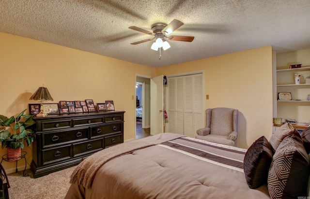 bedroom with carpet flooring, a textured ceiling, a closet, and ceiling fan