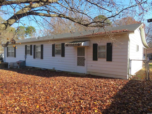 rear view of property featuring central AC