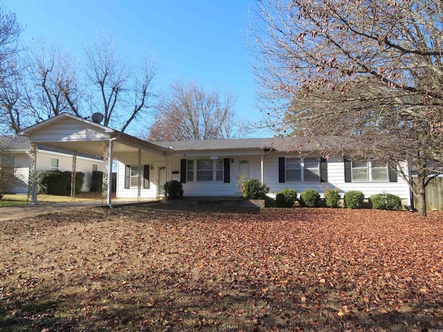 ranch-style house featuring a carport and a porch