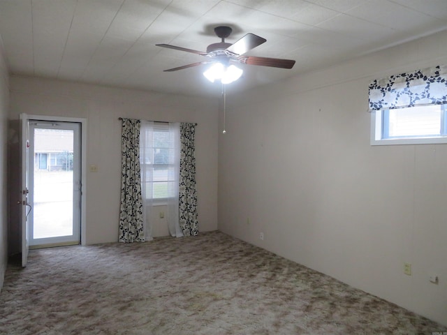 carpeted spare room featuring ceiling fan