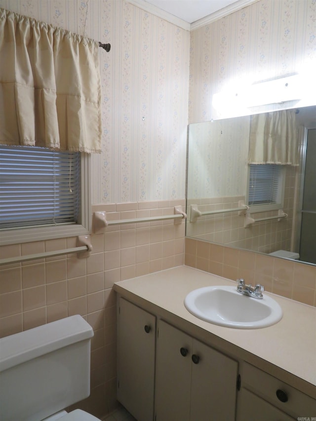 bathroom featuring vanity, toilet, and tile walls