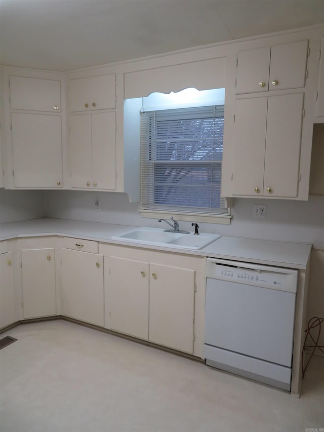 kitchen featuring white dishwasher, white cabinets, and sink