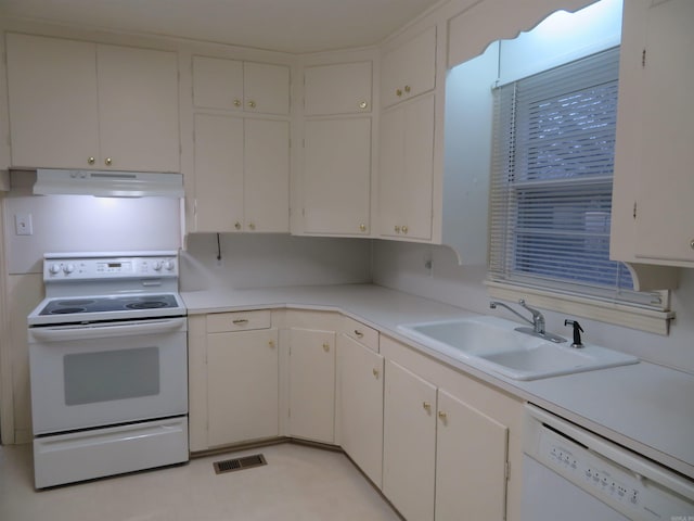 kitchen featuring white appliances, white cabinetry, and sink