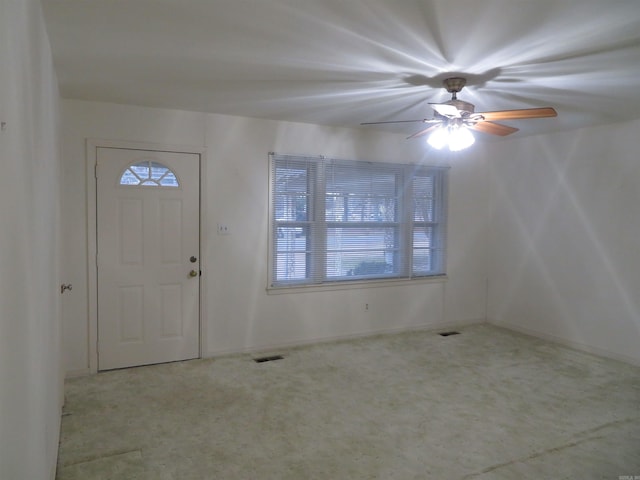 carpeted foyer featuring ceiling fan