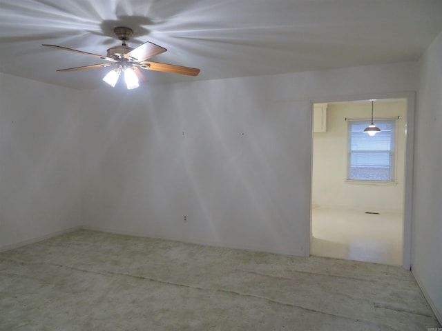 empty room featuring ceiling fan and carpet floors