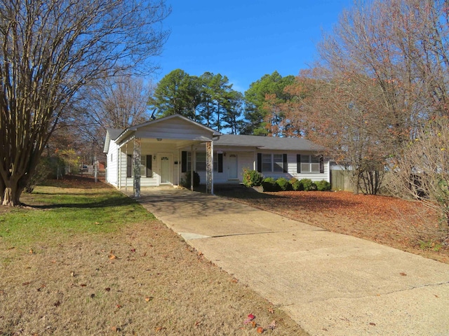 ranch-style home with a front yard and a carport