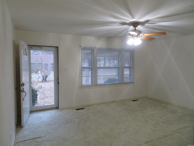 entrance foyer featuring light carpet and ceiling fan