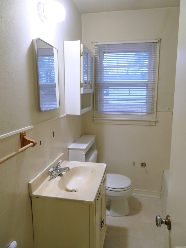 bathroom featuring tile patterned flooring, vanity, and toilet