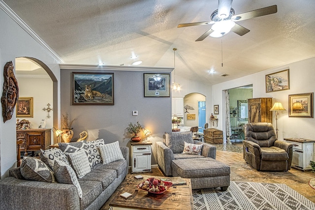 living room with a textured ceiling, vaulted ceiling, ceiling fan, and ornamental molding