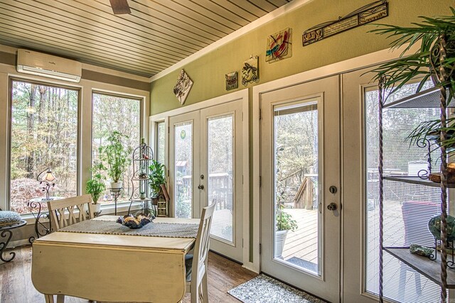 sunroom with french doors, a wall mounted AC, and wood ceiling