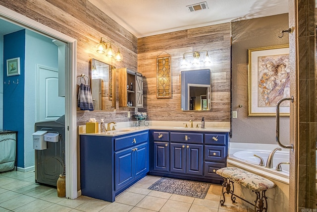 bathroom featuring tile patterned flooring, vanity, a tub to relax in, and wooden walls